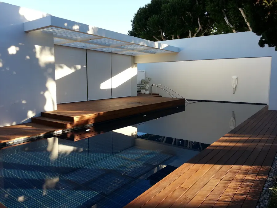 Exterior of a luxurious cabana with exterior roller shades, fully lowered.