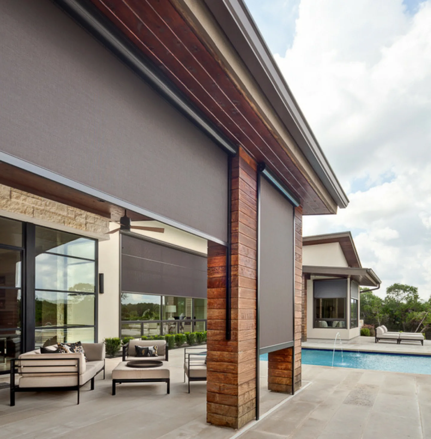 Backyard of a home with custom designed and built exterior screens on the windows.