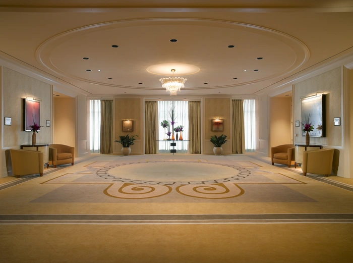 Large hotel lobby with low ceilings and an intricate carpet.