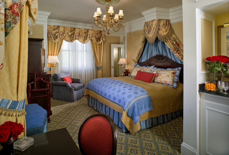 Elaborately decorated hotel suite with intricate drapery custom-designed by Skyco.