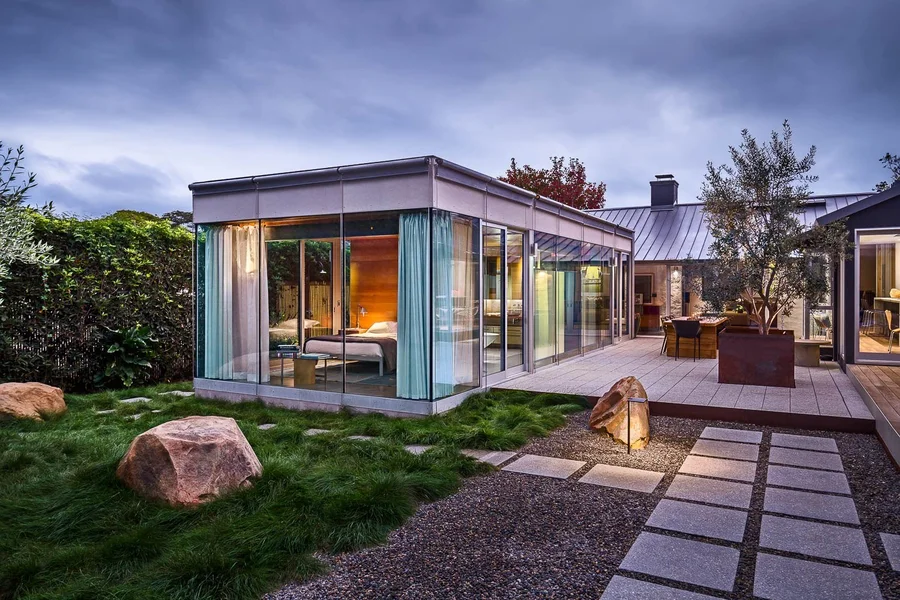 Floor-to-ceiling windows with custom exterior roller shades built by Skyco.