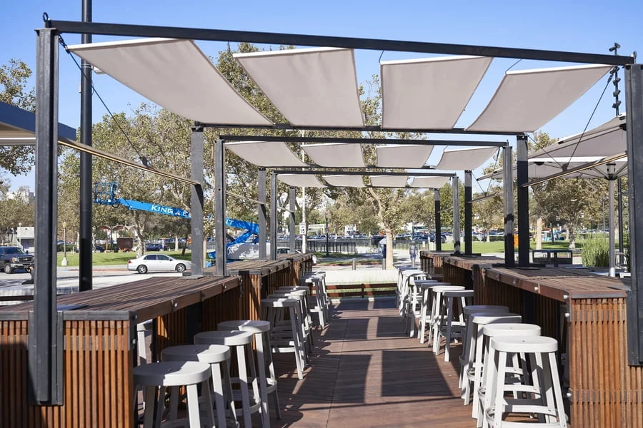 Outdoor dining area with a custom-built shading structure.