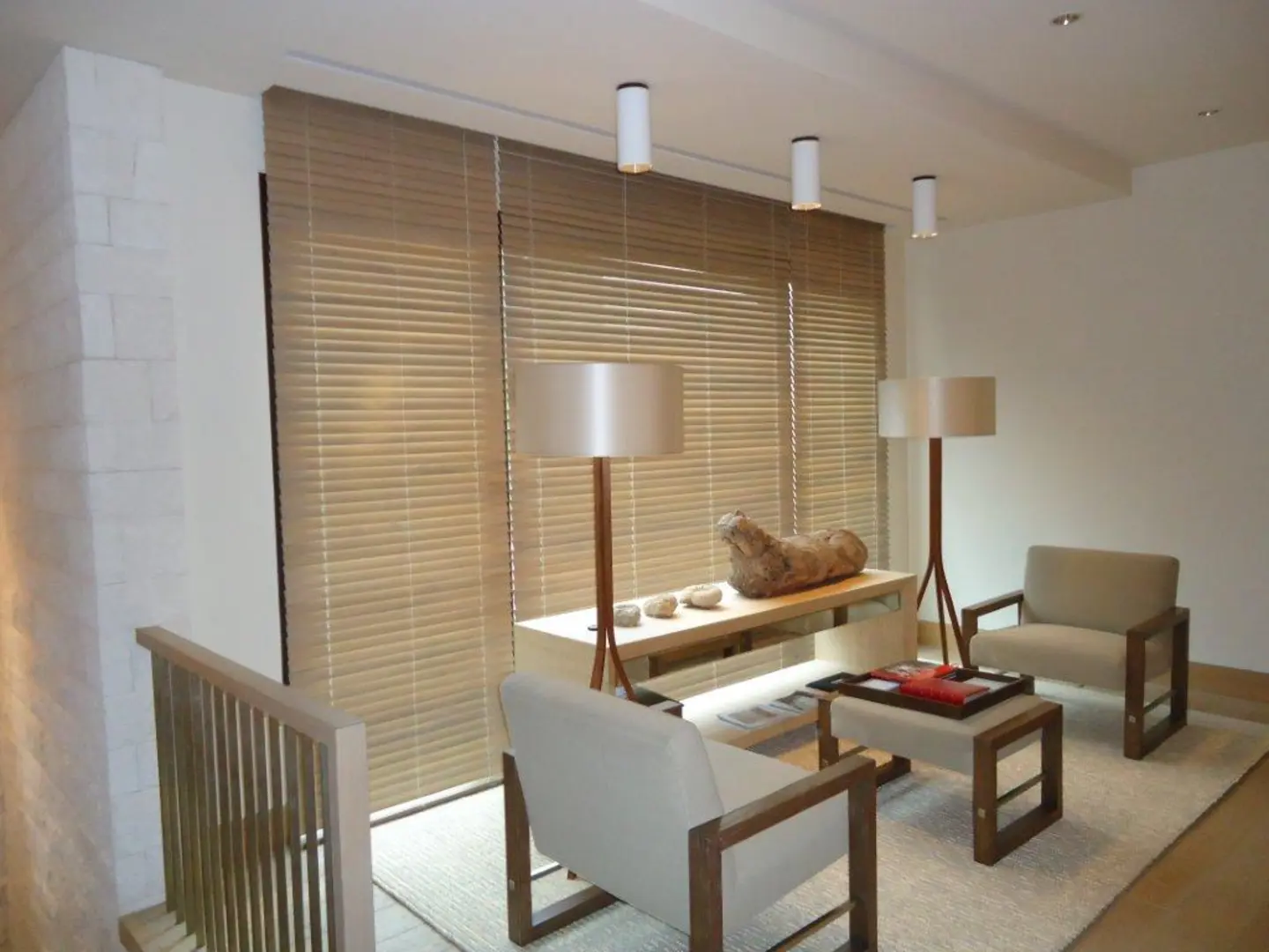 Living room with floor-to-ceiling custom wooden blinds.