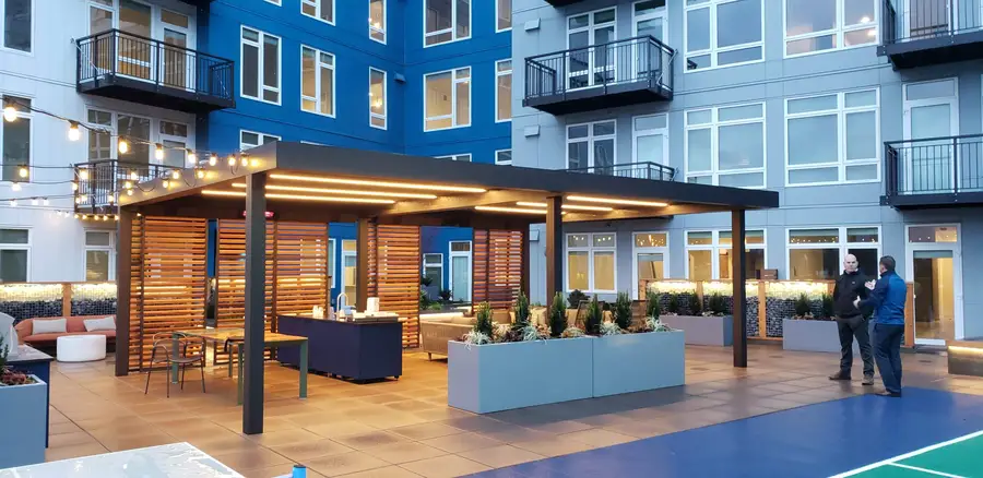 Outdoor living area at an apartment complex with wooden shutters.