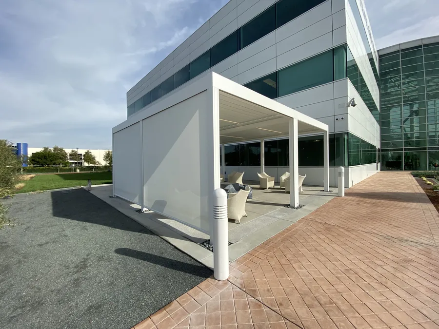 Outdoor seating area at an office building. Roller shades designed and built by Skyco.